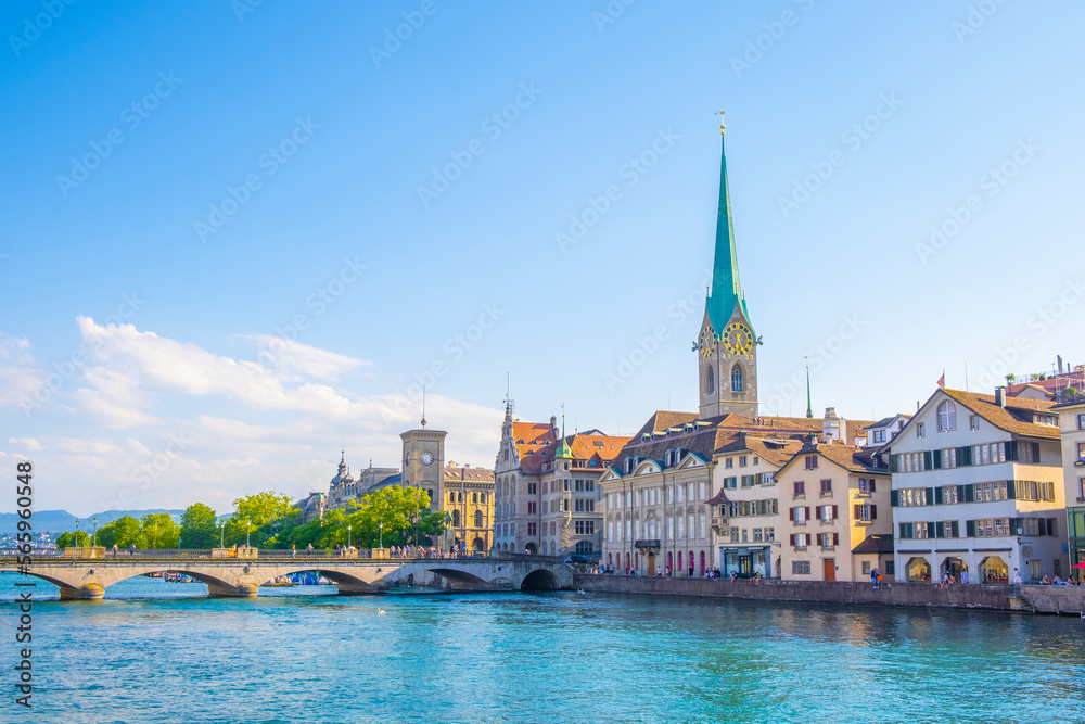 Scenic panoramic view of historic Zürich city center with famous Fraumünster and Grossmünster Church and river Limmat at Lake Zurich on a beautiful sunny day with blue sky in summer, Switzerland Scenic panoramic view of historic Zürich city center with famous Fraumünster and Grossmünster Church and river Limmat at Lake Zurich on a beautiful sunny day with blue sky in summer, Switzerland