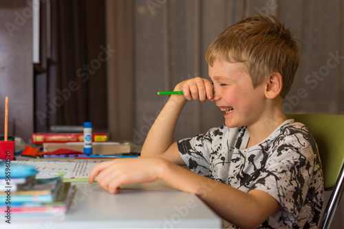 the boy does his homework at home in the evening