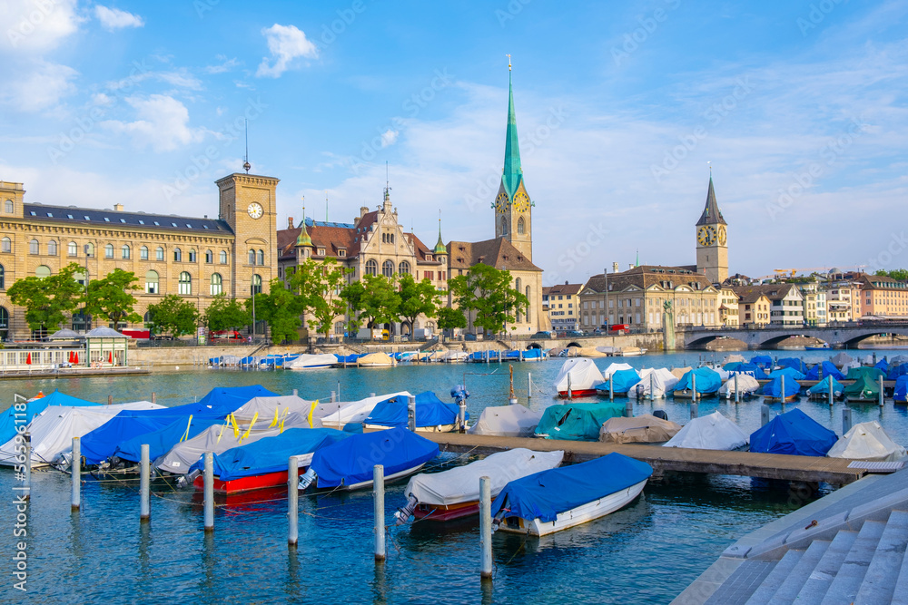 Scenic panoramic view of historic Zürich city center with famous Fraumünster and Grossmünster Church and river Limmat at Lake Zurich on a beautiful sunny day with blue sky in summer, Switzerland