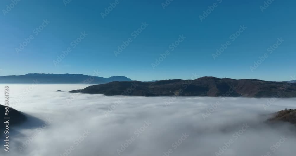 Aerial View. Flying over the high mountains in beautiful clouds. Aerial Drone camera shot. Air pollution clouds over Sarajevo in Bosnia and Herzegovina. Aerial View. Flying over the high mountains in beautiful clouds. Aerial Drone camera shot. Air pollution clouds over Sarajevo in Bosnia and Herzegovina.