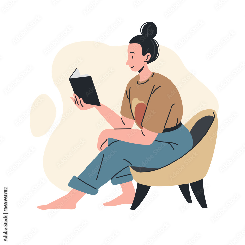 young woman reading a book while sitting in a chair young woman reading a book while sitting in a chair
