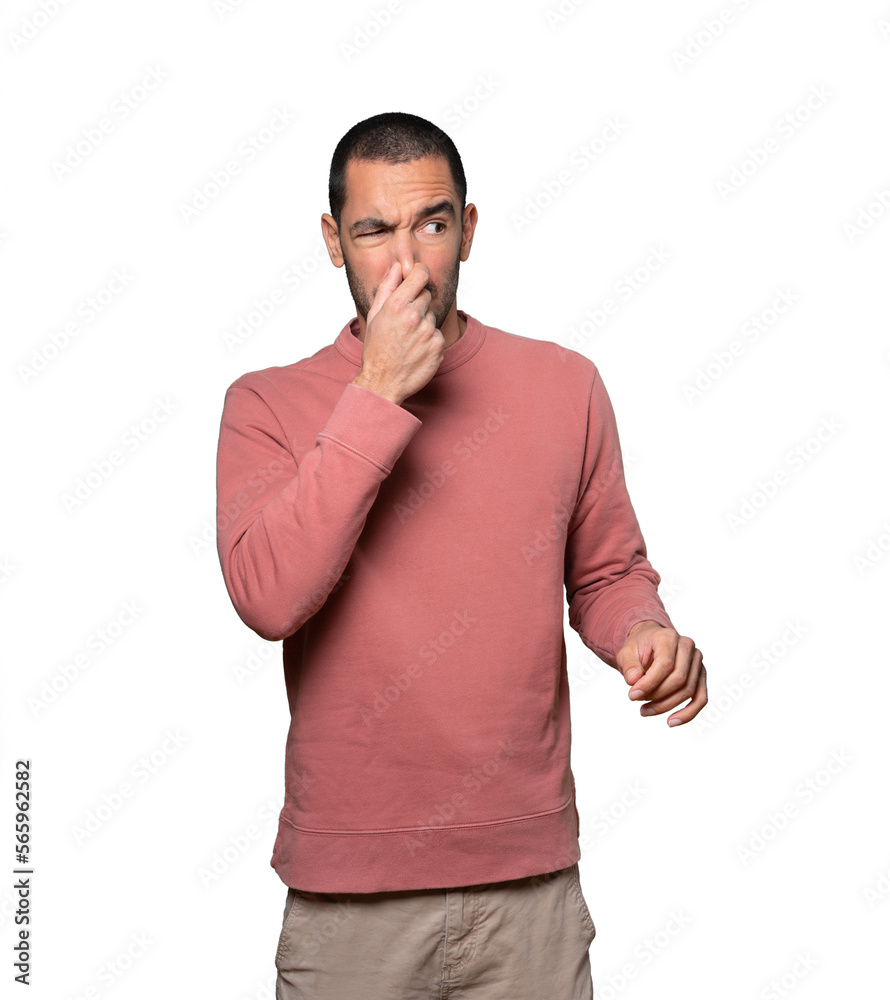 Concerned young man with a gesture of disgust Concerned young man with a gesture of disgust