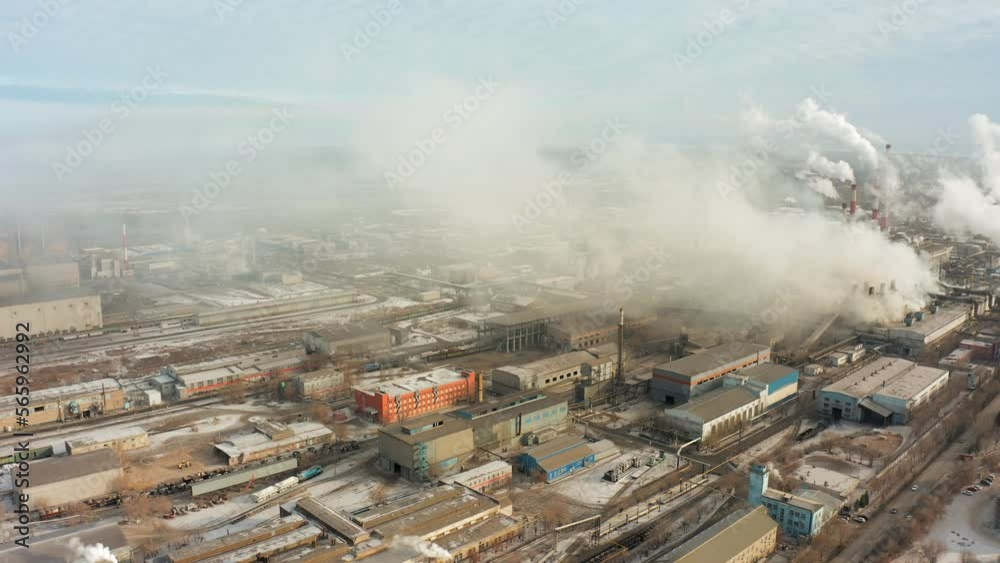 Aktobe plant Kazakhstan. Factory complex with smoking chimneys polluting the air, the environment Aktobe plant Kazakhstan. Factory complex with smoking chimneys polluting the air, the environment