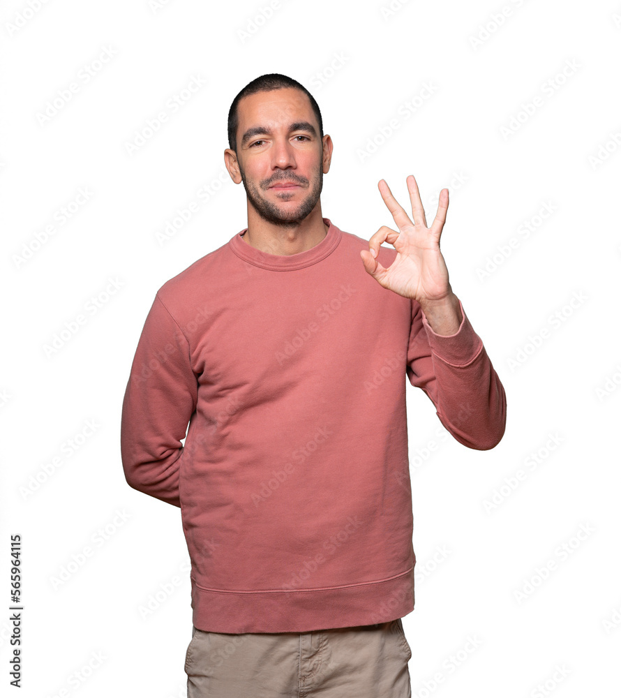 Happy young man doing an all right gesture Happy young man doing an all right gesture