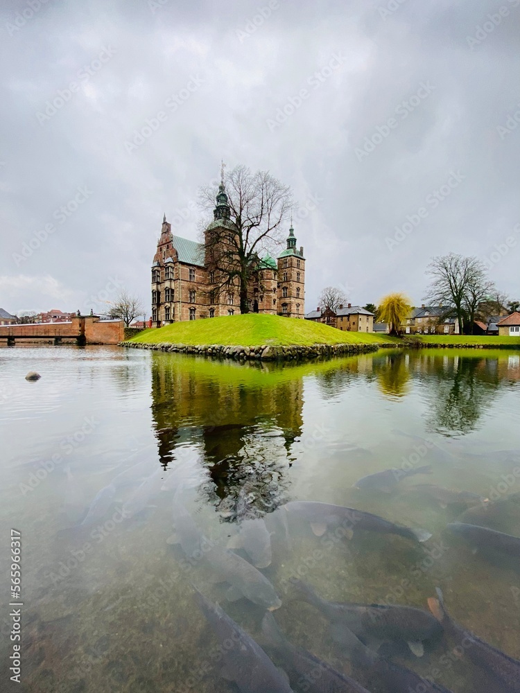 Rosenborg castle and its reflection nect to a lake full of fish