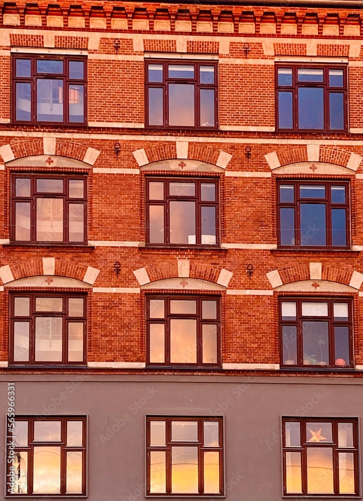 sunset reflected in the windows of a building in copenhagen
