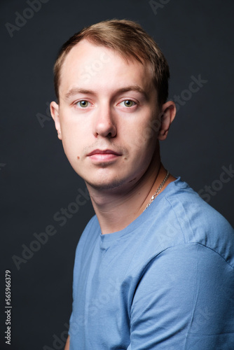 Portrait of young confident blond man in studio