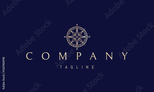 Vector golden logo on which an abstract image of a ships steering wheel in the form of a compass.