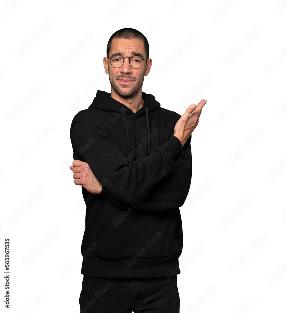 Puzzled young man doing a gesture of not understand Puzzled young man doing a gesture of not understand