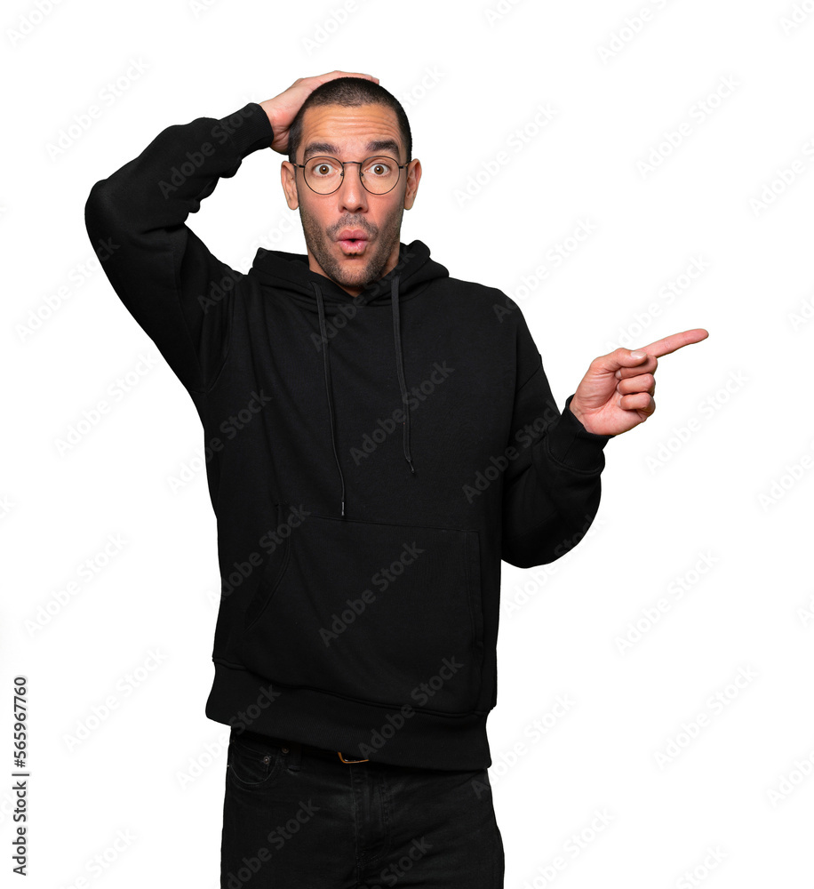 Cool young man pointing with his finger
