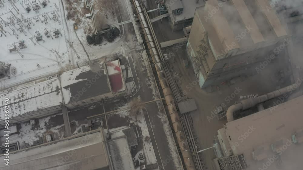 Flying a drone over the smoking chimneys of an industrial factory complex Flying a drone over the smoking chimneys of an industrial factory complex