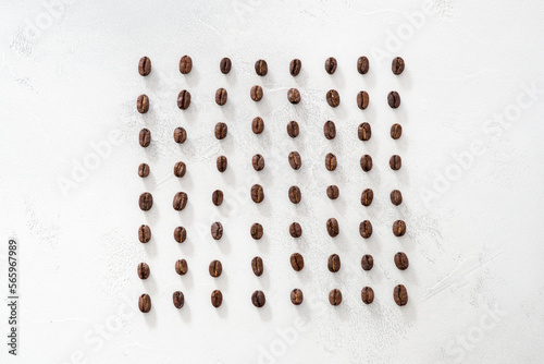 coffee beans arranged symmetrically on a white background  rows and pattern