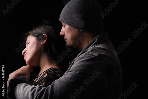 Fotografia Man tenderly hugs woman from behind, expressing his feelings.