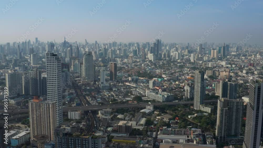 Aerial view of city skyline of Bangkok, cityscape with modern buildings and skyscrapers with clear blue sky behind them - landscape panorama of Thailand from above, Southeast Asia Aerial view of city skyline of Bangkok, cityscape with modern buildings and skyscrapers with clear blue sky behind them - landscape panorama of Thailand from above, Southeast Asia