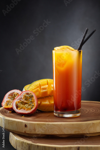 A refreshing cocktail in a glass with passion fruit and mango . photo