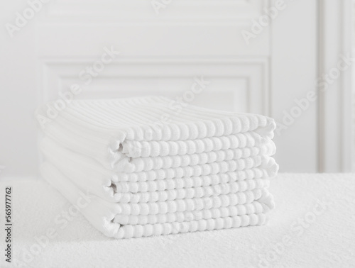 Folded white towels on the bathroom table
