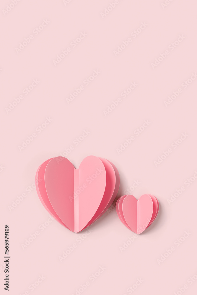 Two Pink paper hearts on pink colored background. Minimal style valentine card or wedding invitation. Cute hearts together on pastel pink, flat lay composition. Valentines Day card concept