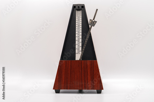 Old fashioned musical metronome isolated on a white background