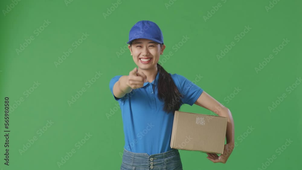Asian Female Courier In Blue Uniform Smiling And Making Honest Gesture While Delivering A Carton On Green Screen Background In The Studio
Asian Female Courier In Blue Uniform Smiling And Making Honest Gesture While Delivering A Carton On Green Screen Background In The Studio