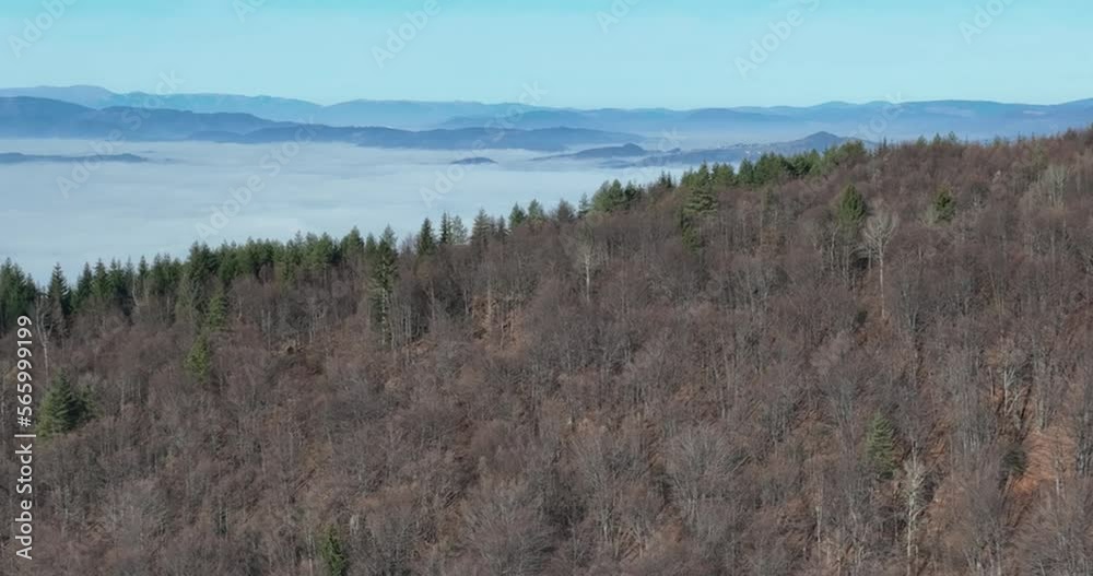 Aerial View. Flying over the high mountains in beautiful clouds. Aerial Drone camera shot. Air pollution clouds over Sarajevo in Bosnia and Herzegovina. Aerial View. Flying over the high mountains in beautiful clouds. Aerial Drone camera shot. Air pollution clouds over Sarajevo in Bosnia and Herzegovina.