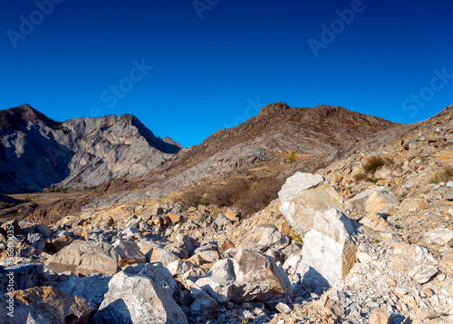 Large pieces of granite stones on the rocks in Altai on a bright day.