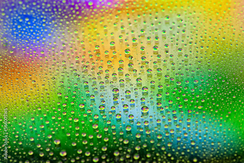Water drops. Texture of the drops. Abstract gradient background. Rainbow green gradient. Highly textured image. Shallow depth of field. Selective focus