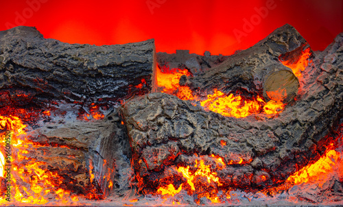 Burning woods in fireplace. Vibrant fire colors. Burning woods and embers. Background pattern. Landscape photography.
