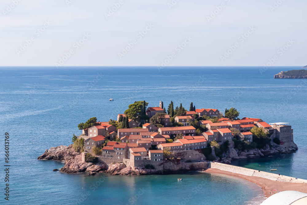 Panoramic view of idyllic island Sveti Stefan (St. Stephen) in the Bay of Budva, Adriatic Mediterranean Sea, Montenegro, Europe. Summer vacation in exclusive luxury hotel complex resort at the seaside
