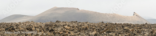 Old volcanic cone surrounded by lava in Tinajo, Lanzarote photo
