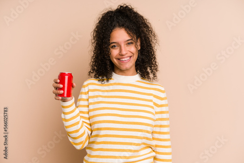 Young african american woman holding a cola refreshment isolated happy, smiling and cheerful.