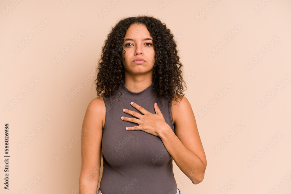 Young african american curly woman isolated taking an oath, putting hand on chest. Young african american curly woman isolated taking an oath, putting hand on chest.