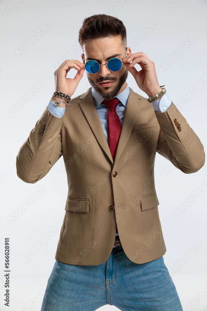 businessman, standing, fixing sunglasses businessman, standing, fixing sunglasses