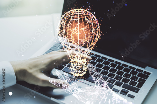 Double exposure of creative light bulb hologram with hands typing on laptop on background, research and development concept © Pixels Hunter