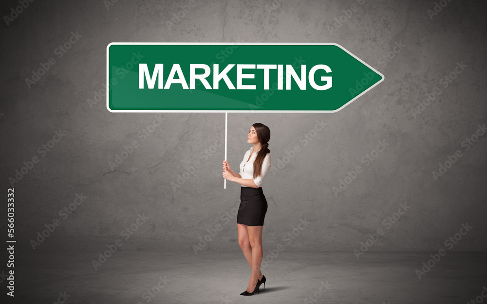 Young business person in casual holding road sign Young business person in casual holding road sign