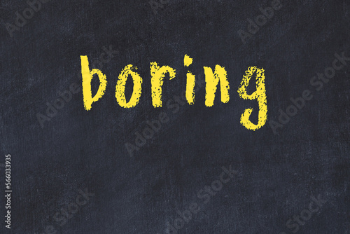 College chalk desk with the word boring written on in
