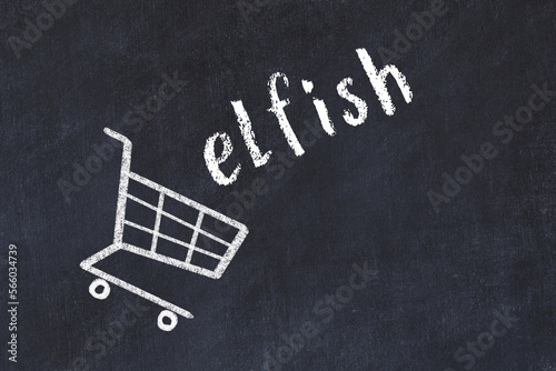 Chalk drawing of shopping cart and word elfish on black chalboard. Concept of globalization and mass consuming