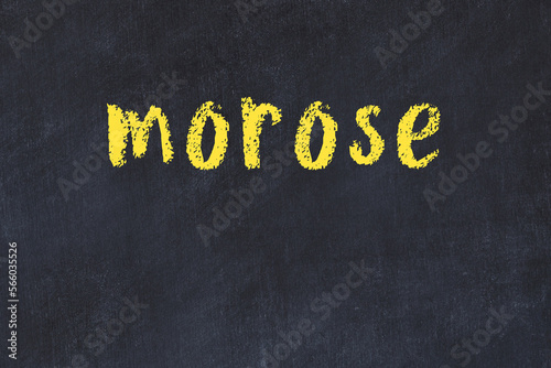 Foto College chalk desk with the word morose written on in