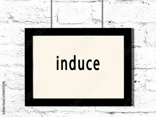 Photography Black frame hanging on white brick wall with inscription induce