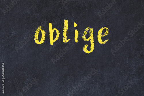Black chalkboard with inscription oblige on in
