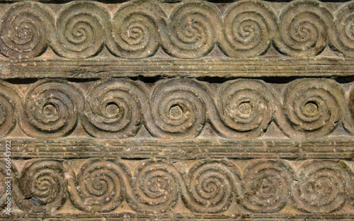 Byzantine ornament, pattern carved in old stone wall photo