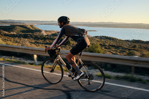 Man rides a gravel bike on the road at sunset.Empty city road. Sports motivation.Murcia region in Spain