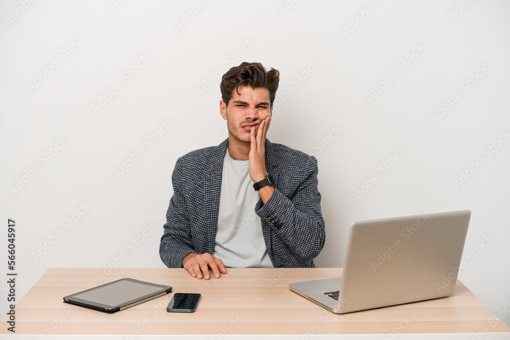 Young entrepreneur man working with a laptop isolated having a strong teeth pain, molar ache. Young entrepreneur man working with a laptop isolated having a strong teeth pain, molar ache.