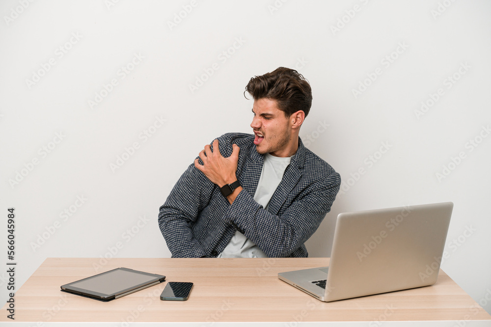 Young entrepreneur man working with a laptop isolated having a shoulder pain. Young entrepreneur man working with a laptop isolated having a shoulder pain.