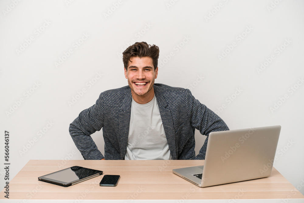 Young entrepreneur man working with a laptop isolated confident keeping hands on hips. Young entrepreneur man working with a laptop isolated confident keeping hands on hips.