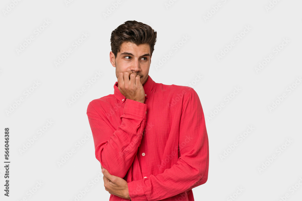 Young handsome caucasian man isolated on white background biting fingernails, nervous and very anxious. Young handsome caucasian man isolated on white background biting fingernails, nervous and very anxious.