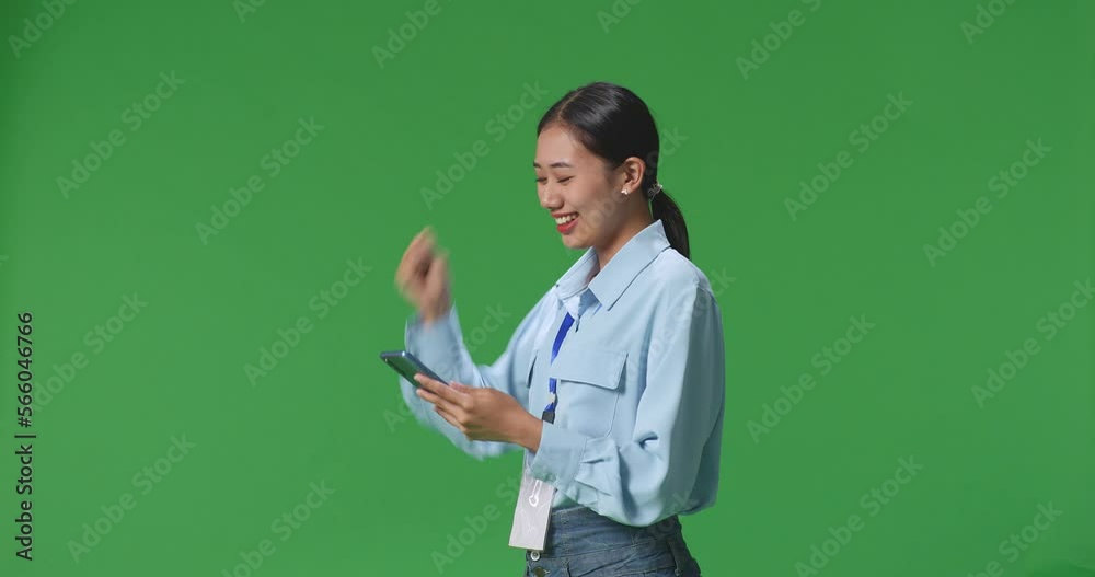 Side View Of Happy Asian Business Woman Celebrating Using Mobile Phone On Green Screen In The Studio
Side View Of Happy Asian Business Woman Celebrating Using Mobile Phone On Green Screen In The Studio