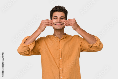 Young handsome caucasian man isolated on white background doubting between two options.