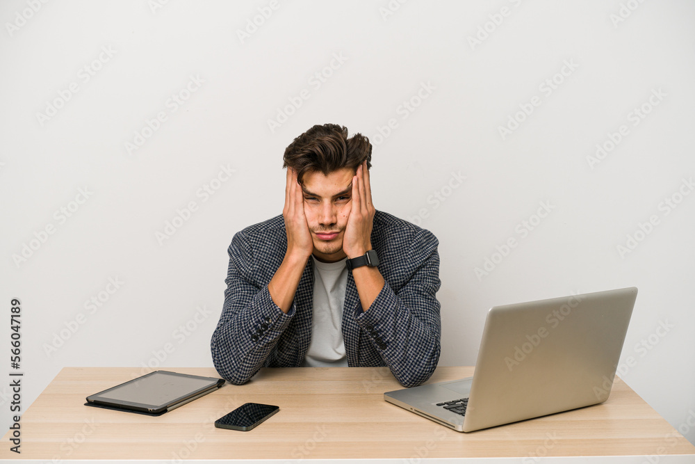 Young caucasian business entrepreneur man working with laptop, mobile phone and tablet Young caucasian business entrepreneur man working with laptop, mobile phone and tablet
