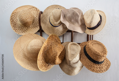 Rack cluttered with hats made from vegetable fibers