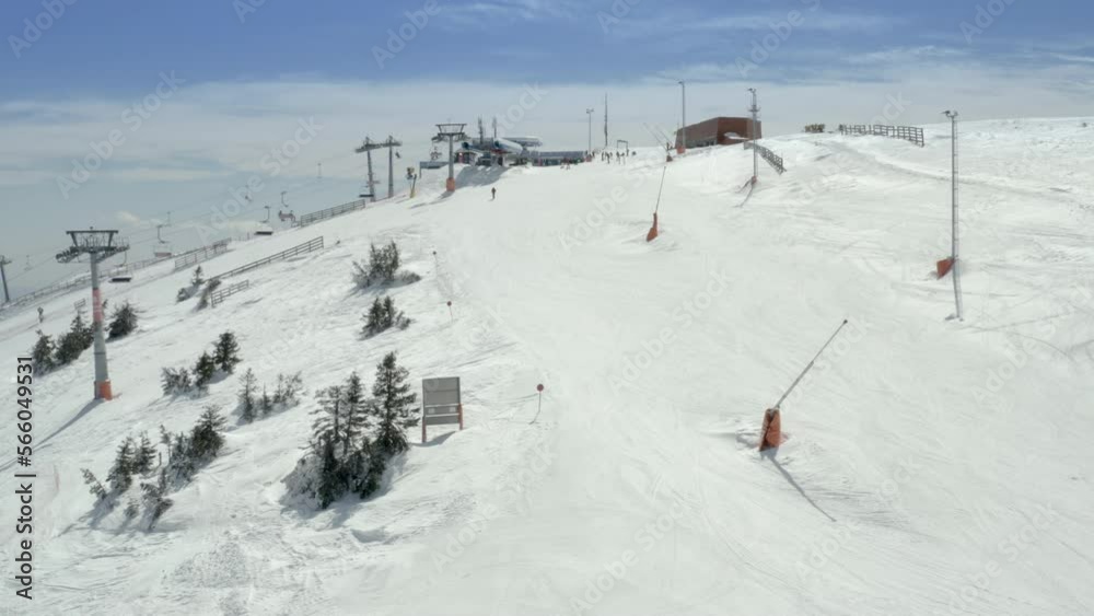 Old ski station on a snowy mountain slope with a lot of people on skis and snowboards Old ski station on a snowy mountain slope with a lot of people on skis and snowboards